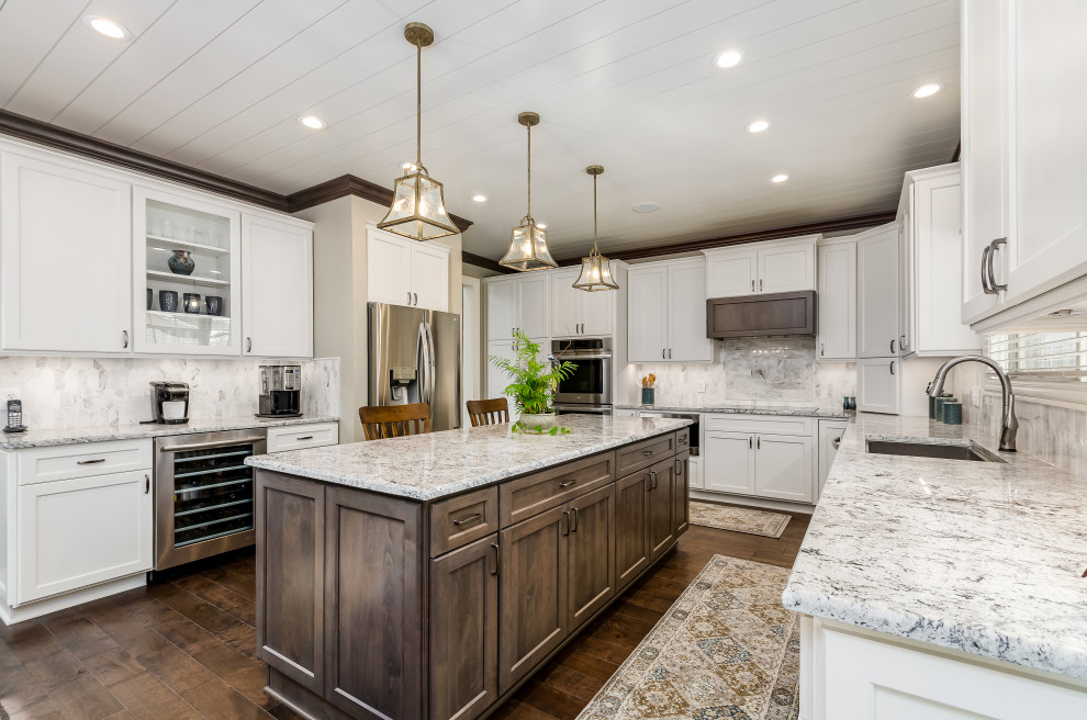 Inspiration for a large transitional u-shaped eat-in kitchen in Columbus with shaker cabinets, granite benchtops, marble splashback and with island.
