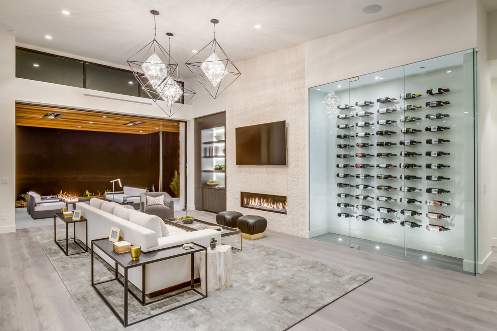 Design ideas for a mid-sized contemporary wine cellar in Boise with light hardwood floors and storage racks.