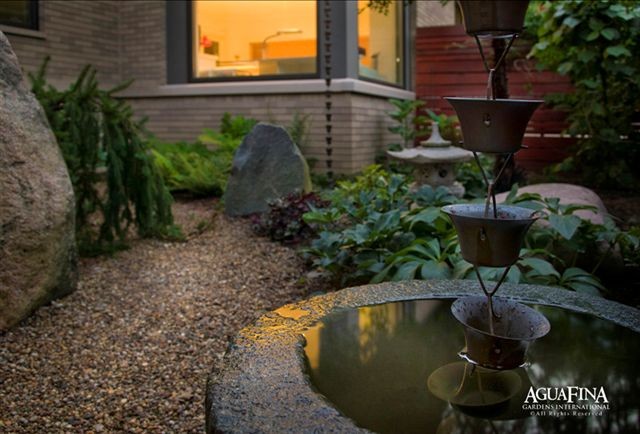 Photo of a mid-sized asian backyard gravel water fountain landscape in Detroit.