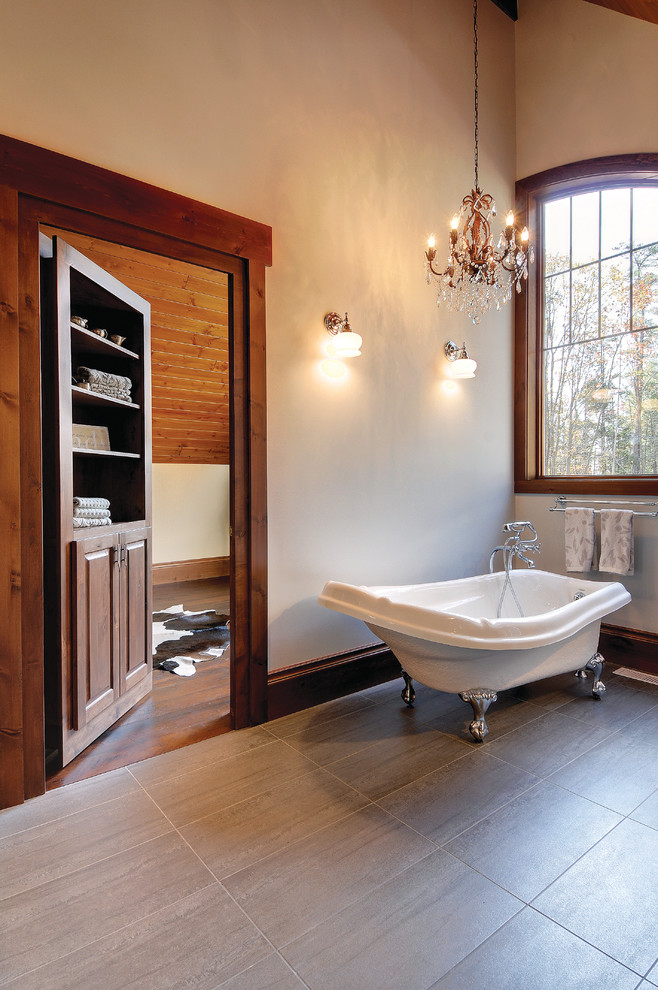 Mid-sized transitional master bathroom in Toronto with raised-panel cabinets, dark wood cabinets, a claw-foot tub, white walls and porcelain floors.