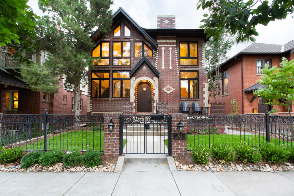 Photo of a traditional three-storey brick red house exterior in Denver with a gable roof.