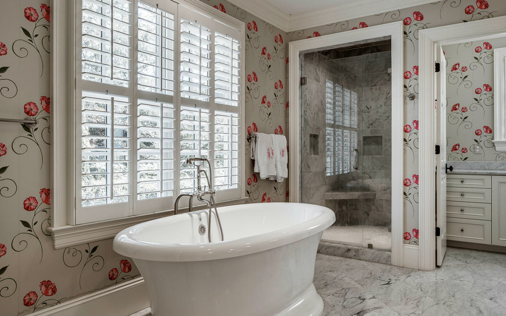 Inspiration for a traditional bathroom in Charlotte with recessed-panel cabinets, white cabinets, a freestanding tub, an alcove shower, gray tile and multi-coloured walls.