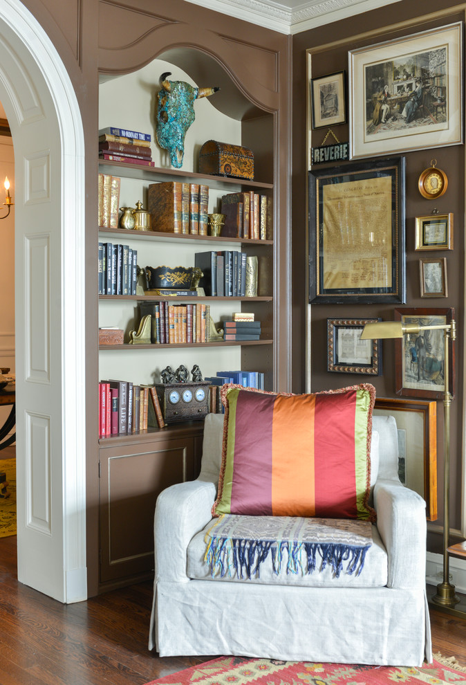 Inspiration for a mid-sized transitional home office in Chicago with a library, brown walls, medium hardwood floors, no fireplace and brown floor.