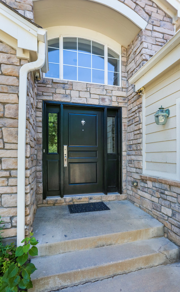 Entryway - mid-sized traditional medium tone wood floor entryway idea in Denver with gray walls and a black front door