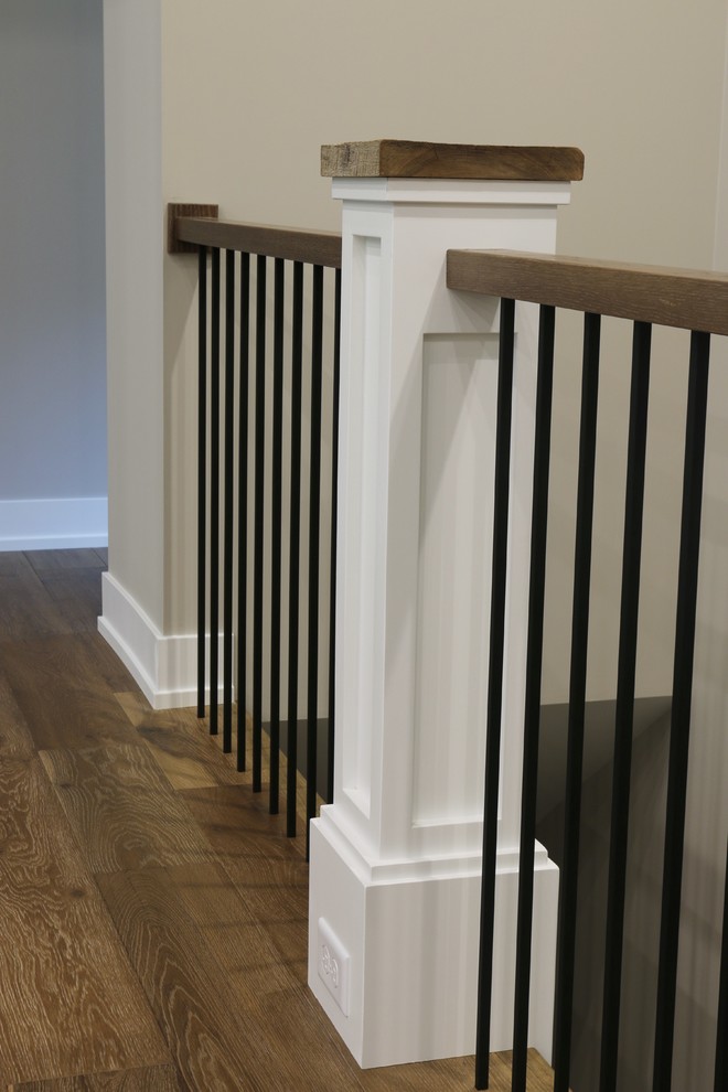 Hallway - mid-sized transitional dark wood floor hallway idea in Grand Rapids with beige walls