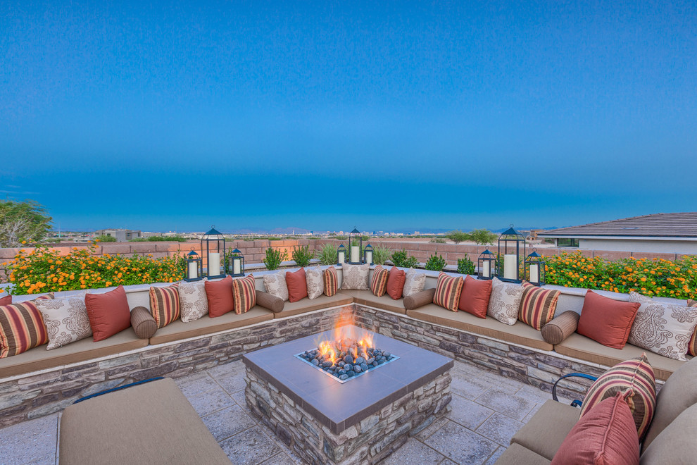 Photo of a large contemporary backyard patio in Las Vegas with natural stone pavers, no cover and a fire feature.