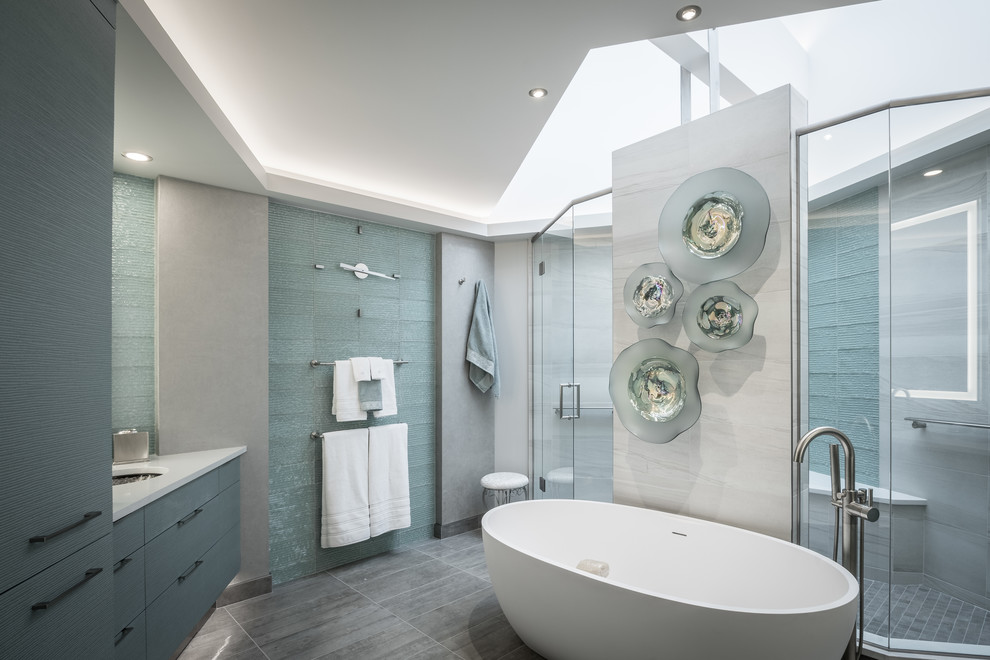Contemporary master bathroom in Other with a freestanding tub, a double shower, green tile, glass tile, grey walls, an undermount sink, engineered quartz benchtops, grey floor, a hinged shower door, flat-panel cabinets, green cabinets and porcelain floors.