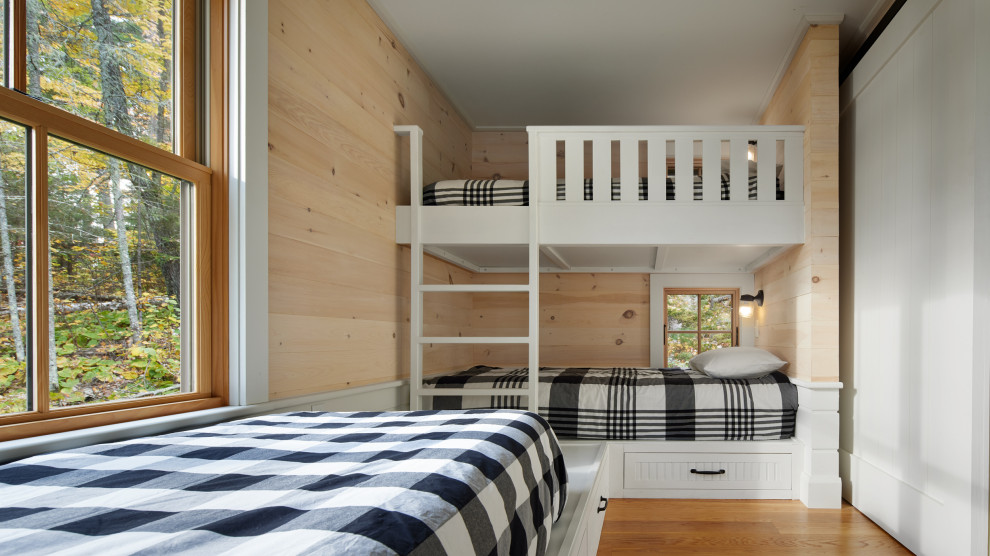 Boundary Waters Retreat - Bedroom danish gender-neutral medium tone wood floor and wood wall kids' bedroom photo in Minneapolis with white walls