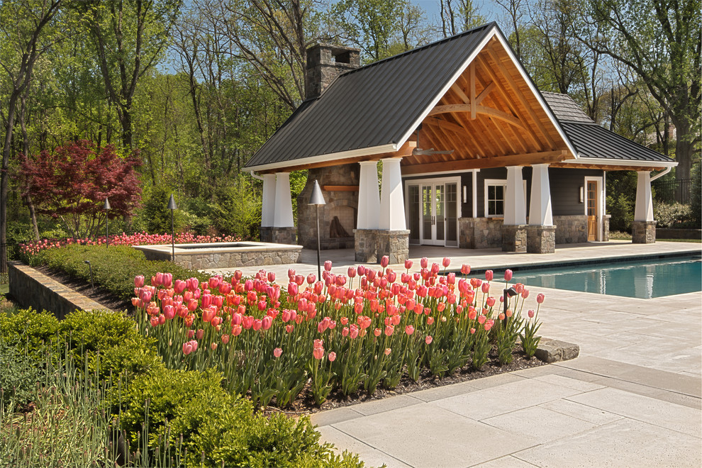 Design ideas for a contemporary backyard pool in DC Metro with a pool house.