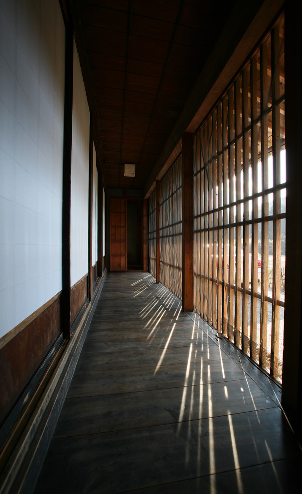 This is an example of an asian hallway in Other with dark hardwood floors.