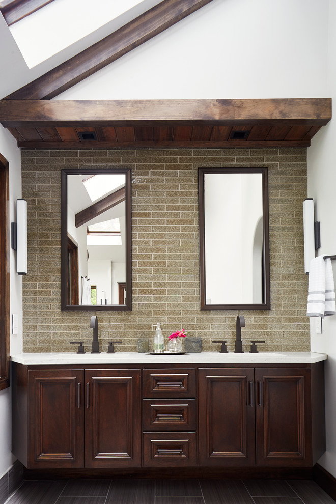 This is an example of a large modern master bathroom in Richmond with raised-panel cabinets, dark wood cabinets, an undermount tub, a curbless shower, a one-piece toilet, gray tile, porcelain tile, white walls, porcelain floors, an undermount sink and concrete benchtops.
