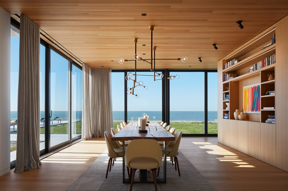 This is an example of a contemporary dining room in Chicago with medium hardwood floors, brown walls and brown floor.