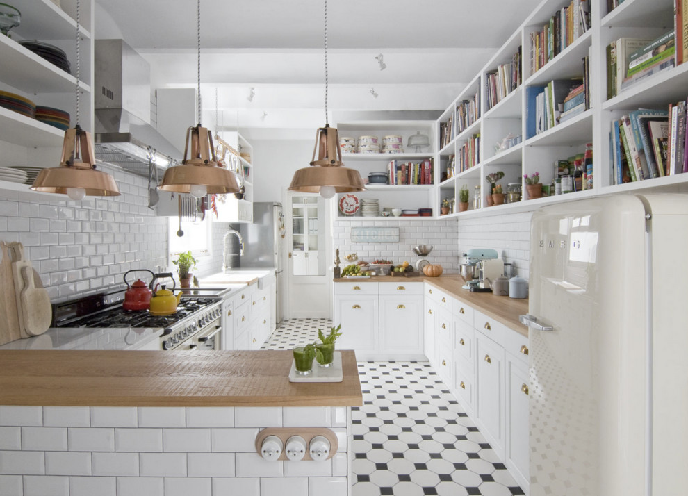 Inspiration for a country u-shaped kitchen in Barcelona with a farmhouse sink, open cabinets, white cabinets, wood benchtops, white splashback, subway tile splashback, white appliances and a peninsula.