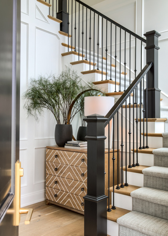 Design ideas for a transitional wood u-shaped staircase in Omaha with painted wood risers and mixed railing.