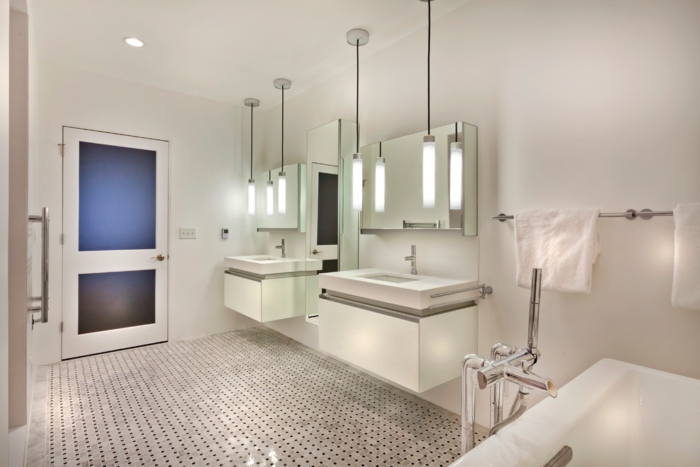 Inspiration for a mid-sized contemporary master bathroom in Minneapolis with an undermount sink, glass-front cabinets, white cabinets, solid surface benchtops, a freestanding tub, an alcove shower, a one-piece toilet, multi-coloured tile, stone tile, white walls and marble floors.