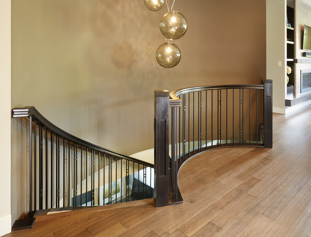 Arts and crafts carpeted curved staircase in Edmonton with open risers and wood railing.