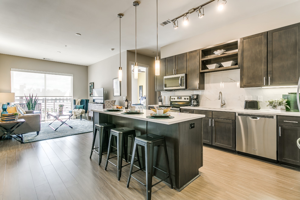 Example of a transitional kitchen design in Dallas with an island