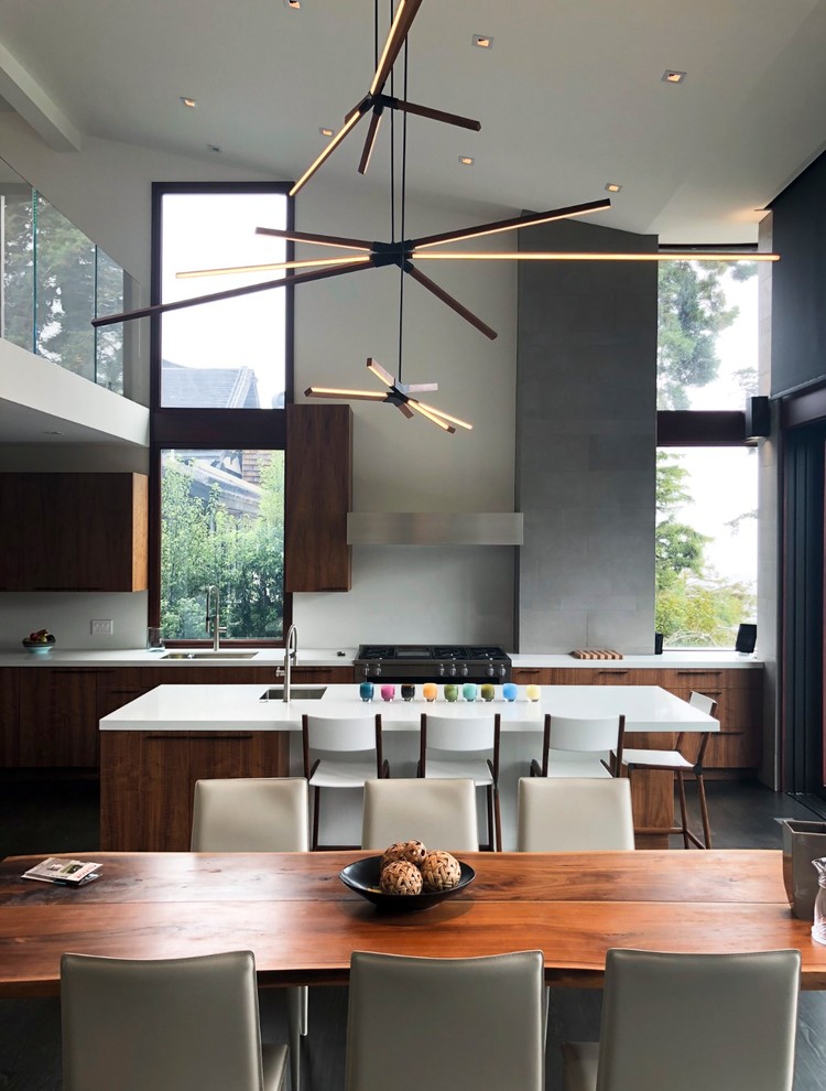Inspiration for a large contemporary single-wall eat-in kitchen in San Francisco with an undermount sink, flat-panel cabinets, dark wood cabinets, quartz benchtops, stainless steel appliances, dark hardwood floors, with island, grey floor and white benchtop.