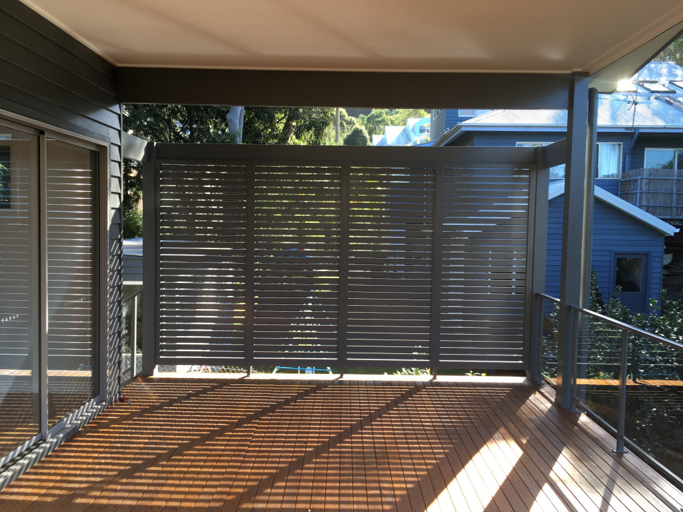 Modern balcony in Wollongong with with privacy feature and metal railing.