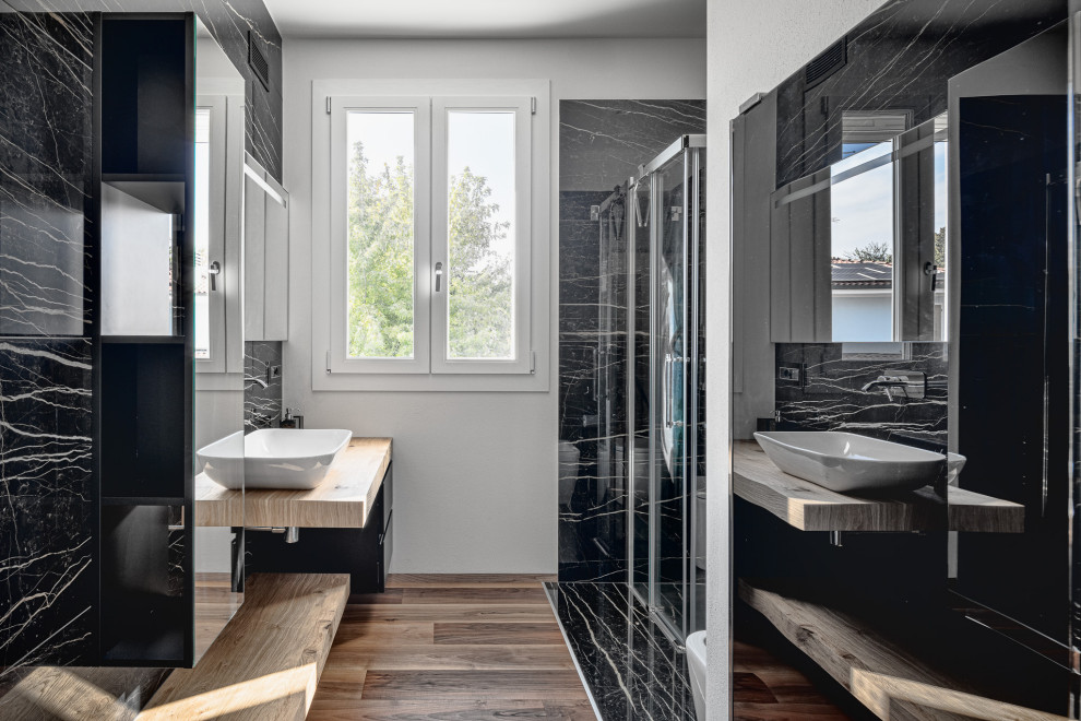 Inspiration for a large contemporary 3/4 bathroom in Other with black cabinets, black tile, a vessel sink, wood benchtops, brown floor, a hinged shower door, white walls, porcelain floors, beige benchtops and a floating vanity.