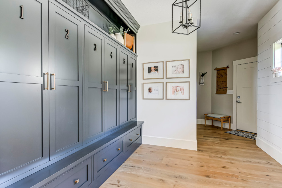 Inspiration for a transitional light wood floor and white floor foyer remodel in Chicago