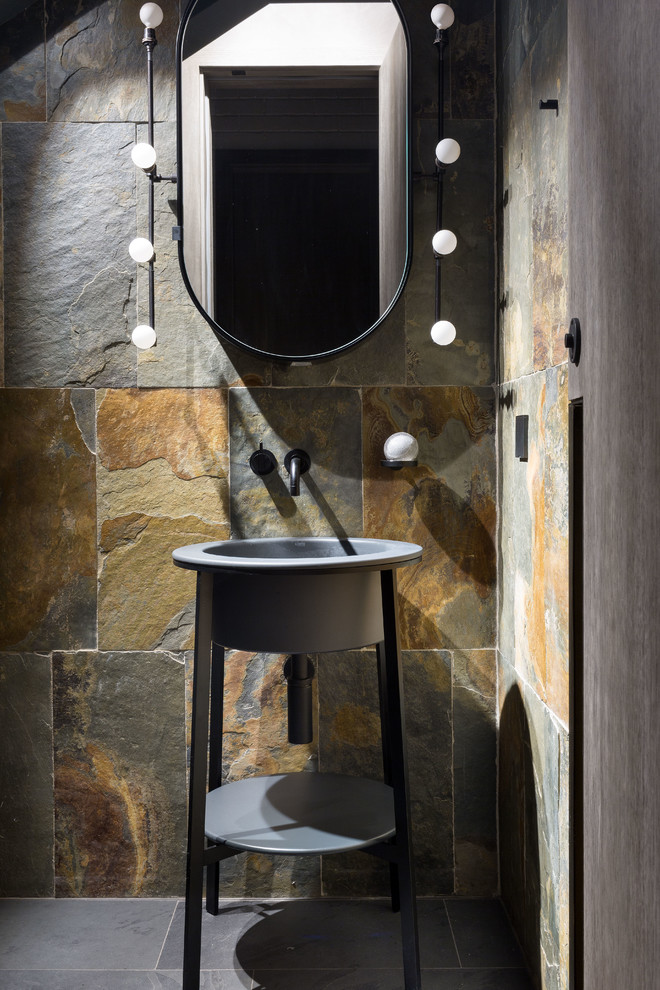 This is an example of a small industrial powder room in Moscow with slate, slate floors, a pedestal sink, brown tile, gray tile and grey floor.