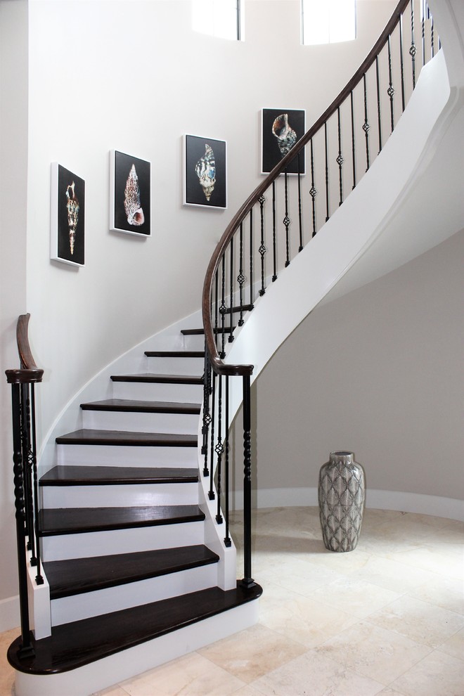 Inspiration for a large transitional wood spiral staircase in Tampa with mixed railing.
