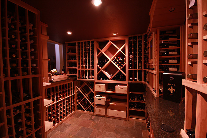 Example of a mountain style wine cellar design in Denver with storage racks