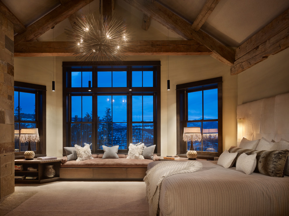 Example of a mountain style master carpeted bedroom design in Denver with beige walls