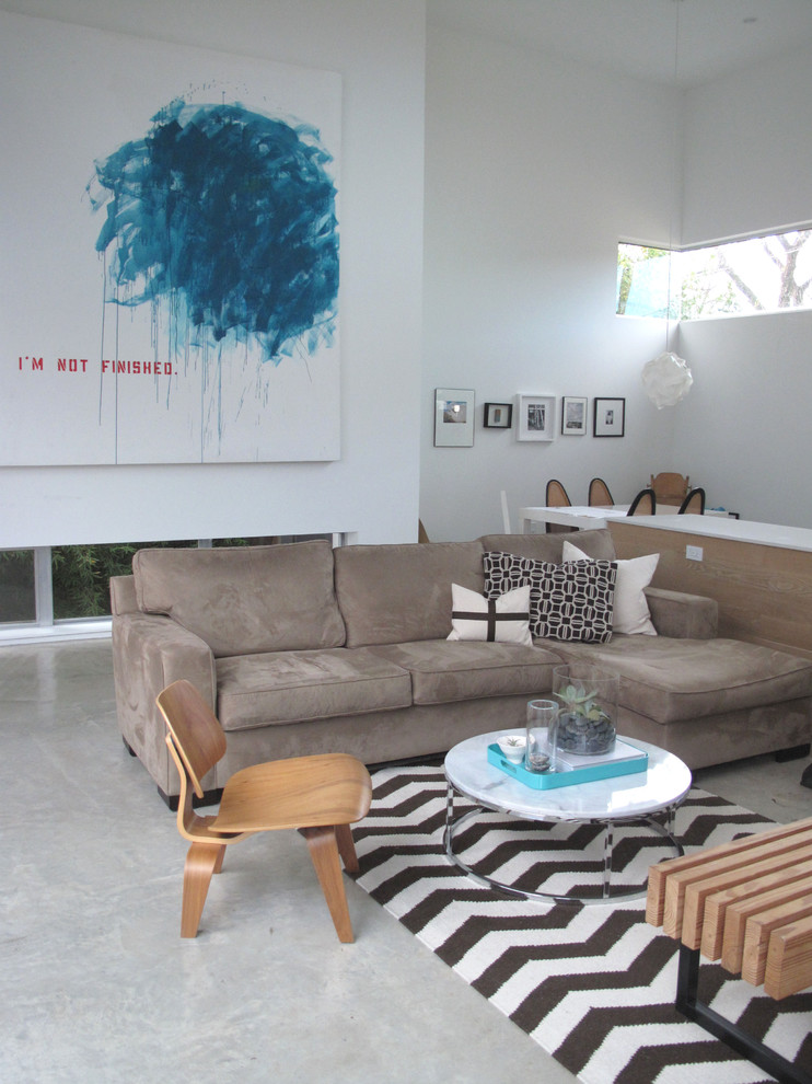 Photo of a contemporary living room in Austin with concrete floors.