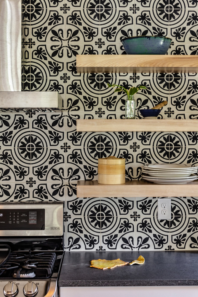 Inspiration for a large transitional u-shaped ceramic tile and multicolored floor open concept kitchen remodel with a drop-in sink, flat-panel cabinets, white cabinets, quartz countertops, multicolored backsplash, cement tile backsplash, stainless steel appliances, an island and gray countertops
