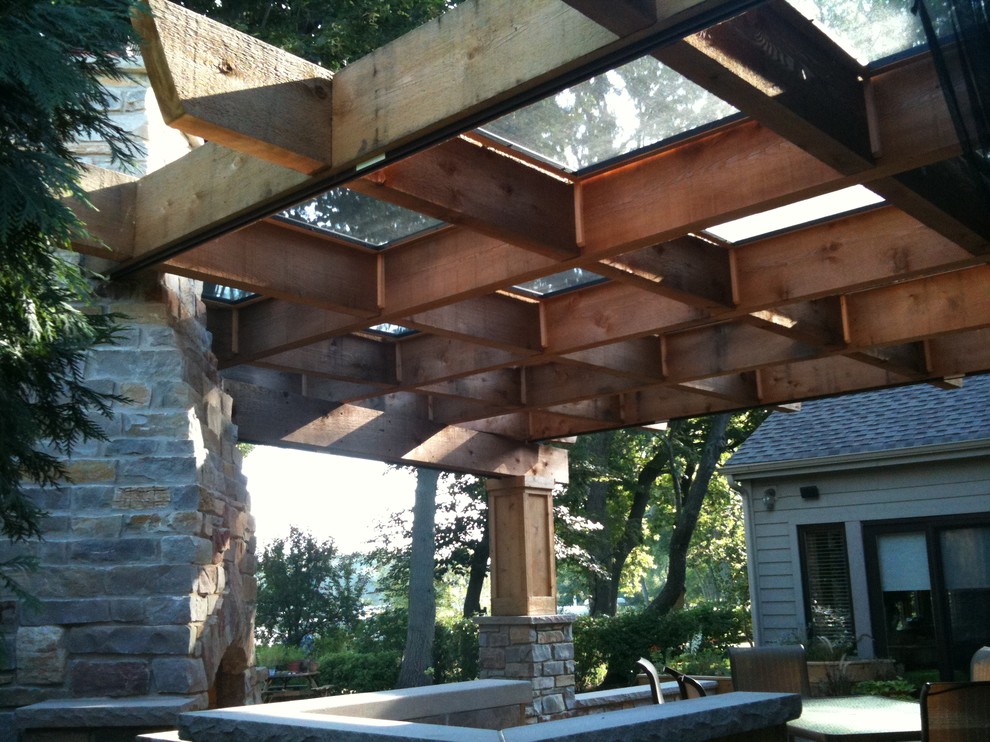 Design ideas for a large country backyard deck in Chicago with a fire feature and a pergola.