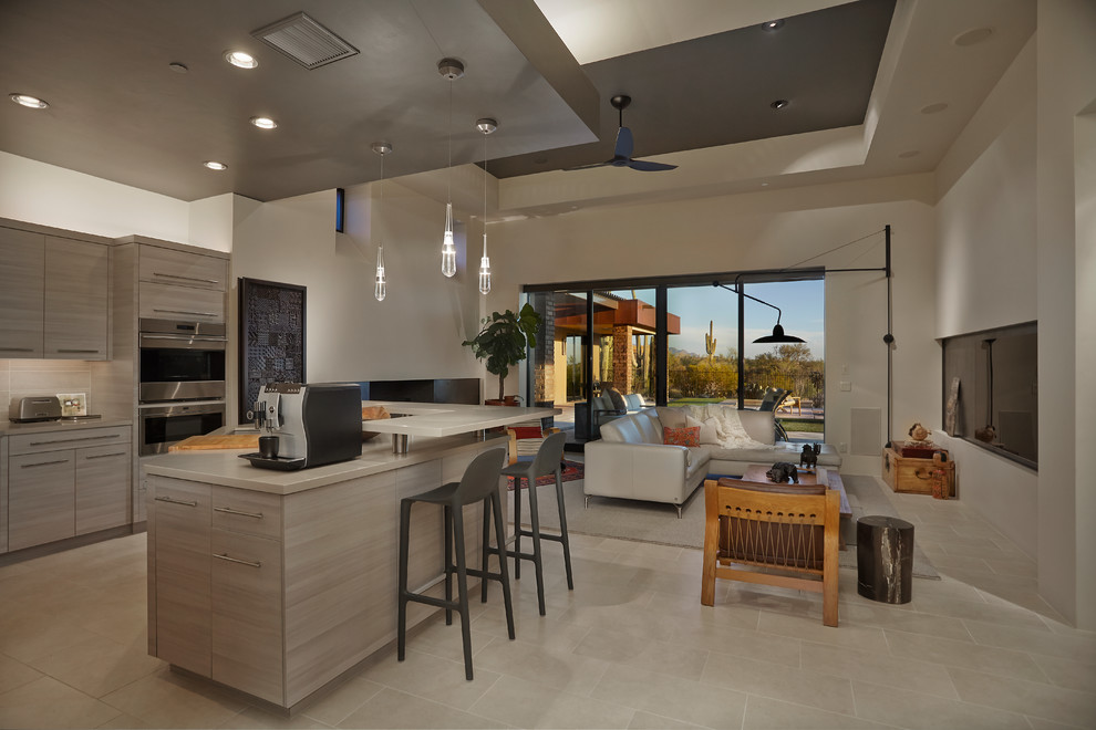 Photo of a contemporary open plan kitchen in Phoenix with porcelain floors, flat-panel cabinets, light wood cabinets, stainless steel appliances and with island.