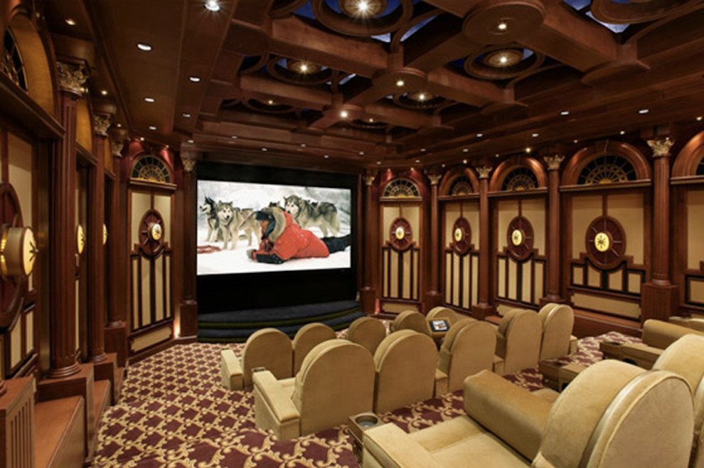This is an example of a large traditional enclosed home theatre in Los Angeles with carpet and a projector screen.