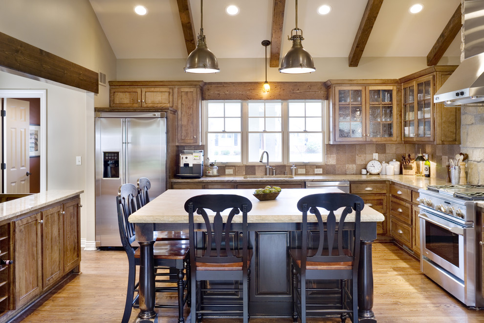 Inspiration for a large traditional l-shaped open plan kitchen in Kansas City with glass-front cabinets, stainless steel appliances, an undermount sink, dark wood cabinets, granite benchtops, brown splashback, stone tile splashback, medium hardwood floors and with island.