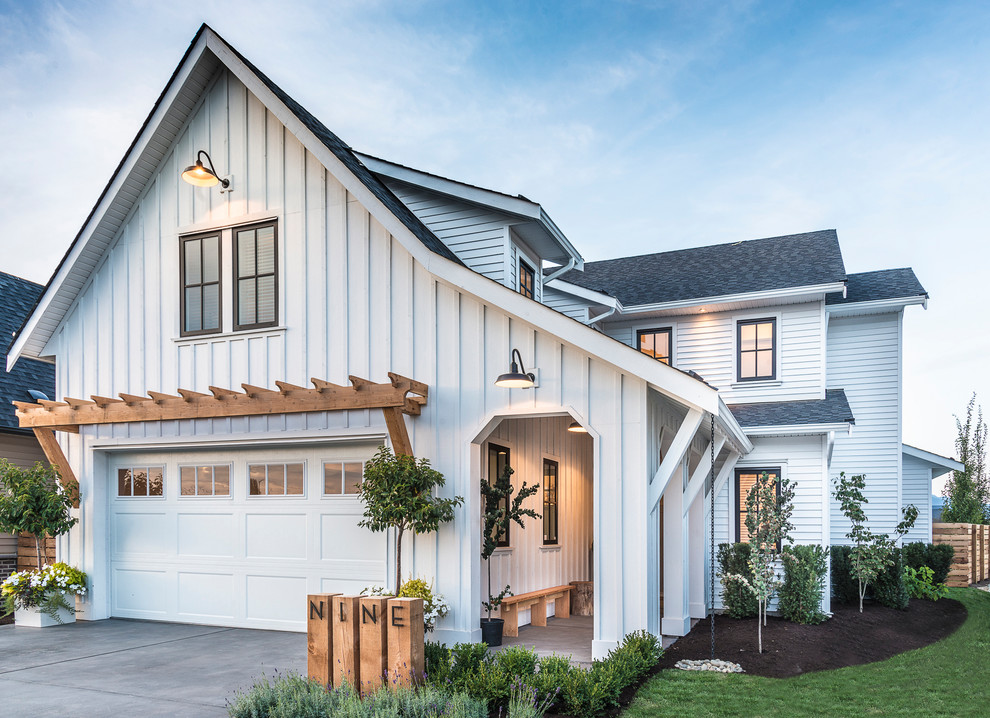 Country two-storey white house exterior in Vancouver with mixed siding, a gable roof and a shingle roof.