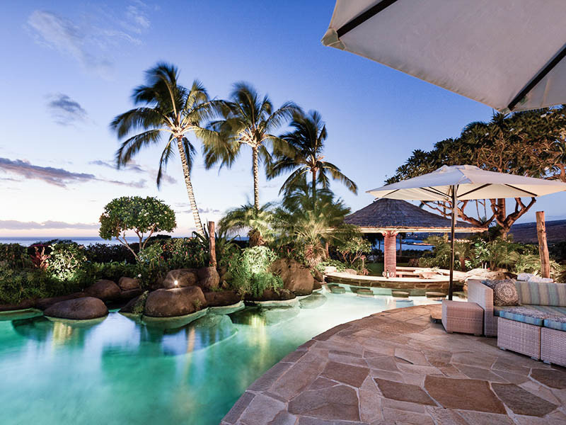 Huge island style backyard stone and custom-shaped natural pool landscaping photo in Hawaii