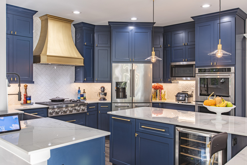 Inspiration for a mid-sized transitional u-shaped gray floor open concept kitchen remodel in DC Metro with a farmhouse sink, recessed-panel cabinets, blue cabinets, quartz countertops, white backsplash, subway tile backsplash, stainless steel appliances, an island and white countertops