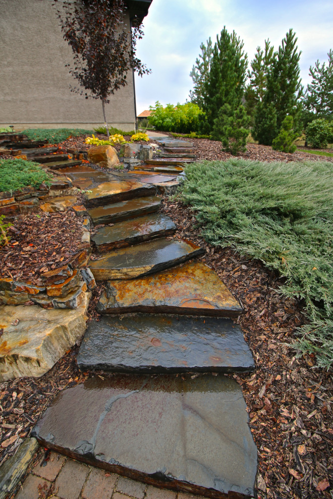This is an example of a huge rustic backyard landscaping in Edmonton.