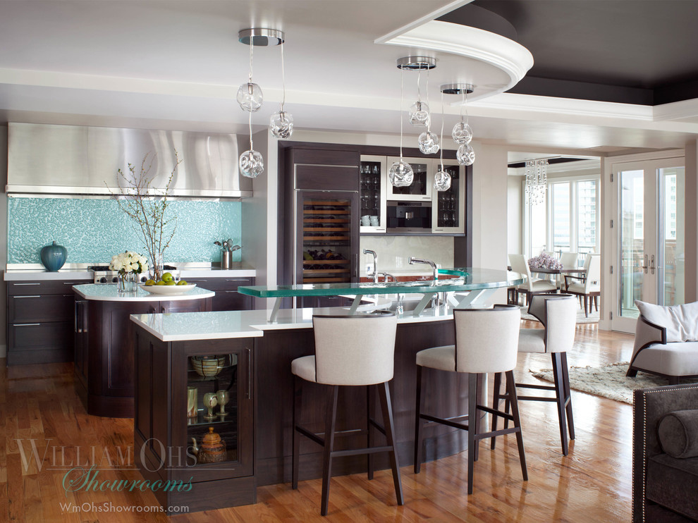 Eat-in kitchen - transitional l-shaped eat-in kitchen idea in Denver with a drop-in sink, beaded inset cabinets, brown cabinets, quartz countertops, glass sheet backsplash and stainless steel appliances
