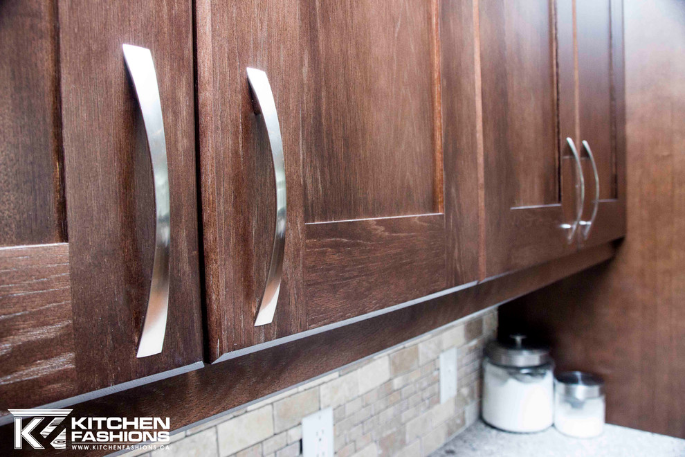 Large transitional u-shaped medium tone wood floor open concept kitchen photo with a farmhouse sink, shaker cabinets, dark wood cabinets, quartz countertops, brown backsplash, stone tile backsplash, stainless steel appliances and an island