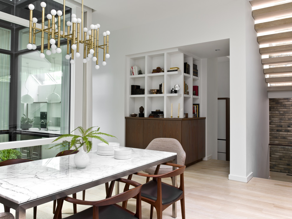 Design ideas for a mid-sized contemporary open plan dining in Chicago with white walls, light hardwood floors and no fireplace.