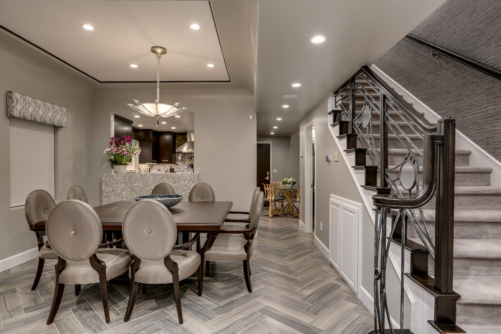 Mid-sized transitional open plan dining in Los Angeles with grey walls and porcelain floors.