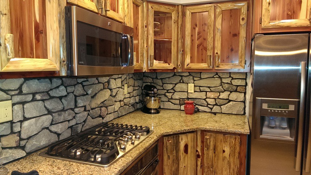 Eat-in kitchen - small rustic u-shaped ceramic tile eat-in kitchen idea with a double-bowl sink, shaker cabinets, distressed cabinets, granite countertops, gray backsplash, stone slab backsplash, stainless steel appliances and an island