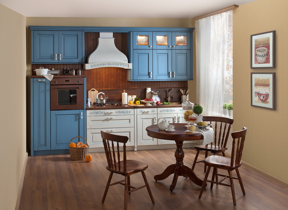 Mid-sized country single-wall eat-in kitchen in Moscow with a drop-in sink, raised-panel cabinets, blue cabinets, laminate benchtops, brown splashback, timber splashback, coloured appliances, no island and brown benchtop.