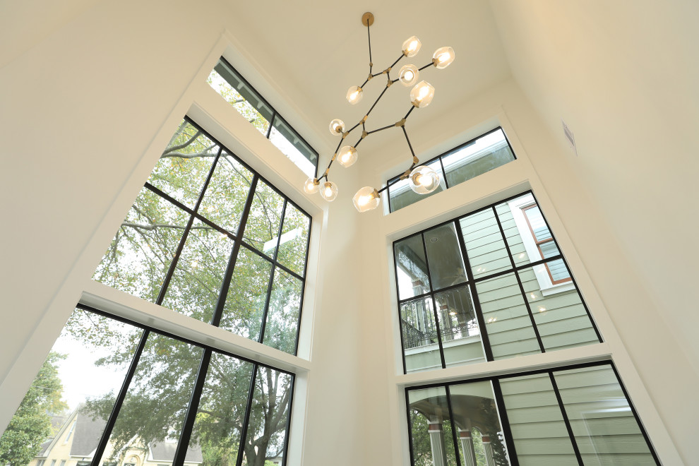 Inspiration for an expansive country study room in Houston with white walls and light hardwood floors.