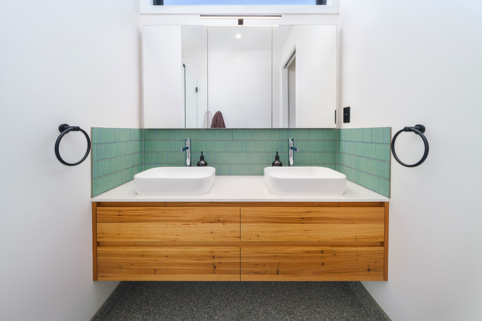Inspiration for a contemporary bathroom in Other with medium wood cabinets, green tile, matchstick tile, ceramic floors, engineered quartz benchtops, white benchtops, a double vanity and a floating vanity.