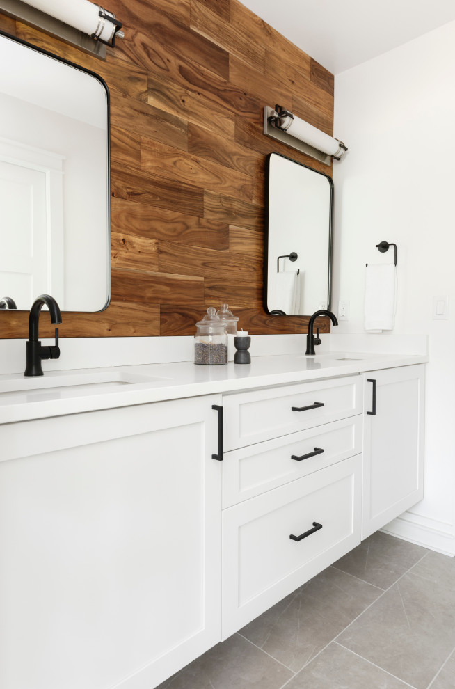 Design ideas for a mid-sized country bathroom in Portland with flat-panel cabinets, medium wood cabinets, an alcove tub, an alcove shower, a two-piece toilet, white tile, ceramic tile, white walls, porcelain floors, an undermount sink, engineered quartz benchtops, grey floor, a sliding shower screen, white benchtops, an enclosed toilet, a double vanity, a floating vanity and wood walls.