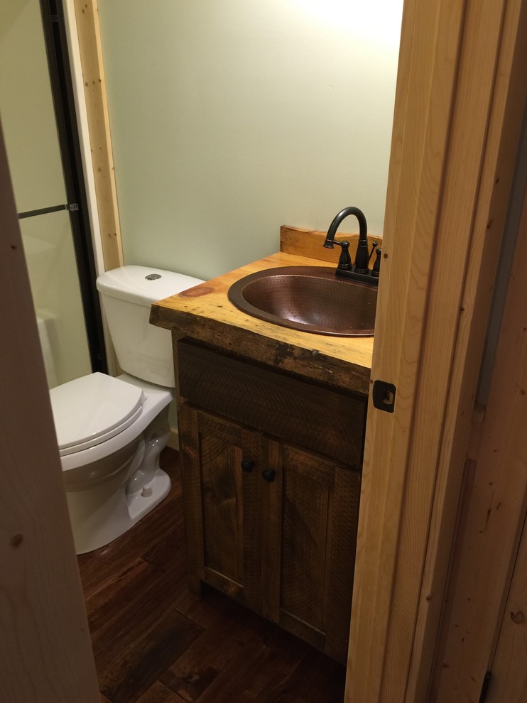 Photo of a mid-sized country kids bathroom in Atlanta with recessed-panel cabinets, medium wood cabinets, medium hardwood floors and wood benchtops.