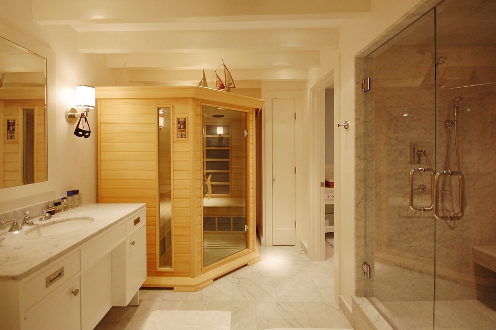 Photo of a large contemporary bathroom in Boston with marble benchtops, with a sauna, flat-panel cabinets, white cabinets, an alcove shower, gray tile, white tile, marble, white walls, marble floors, an undermount sink and a hinged shower door.